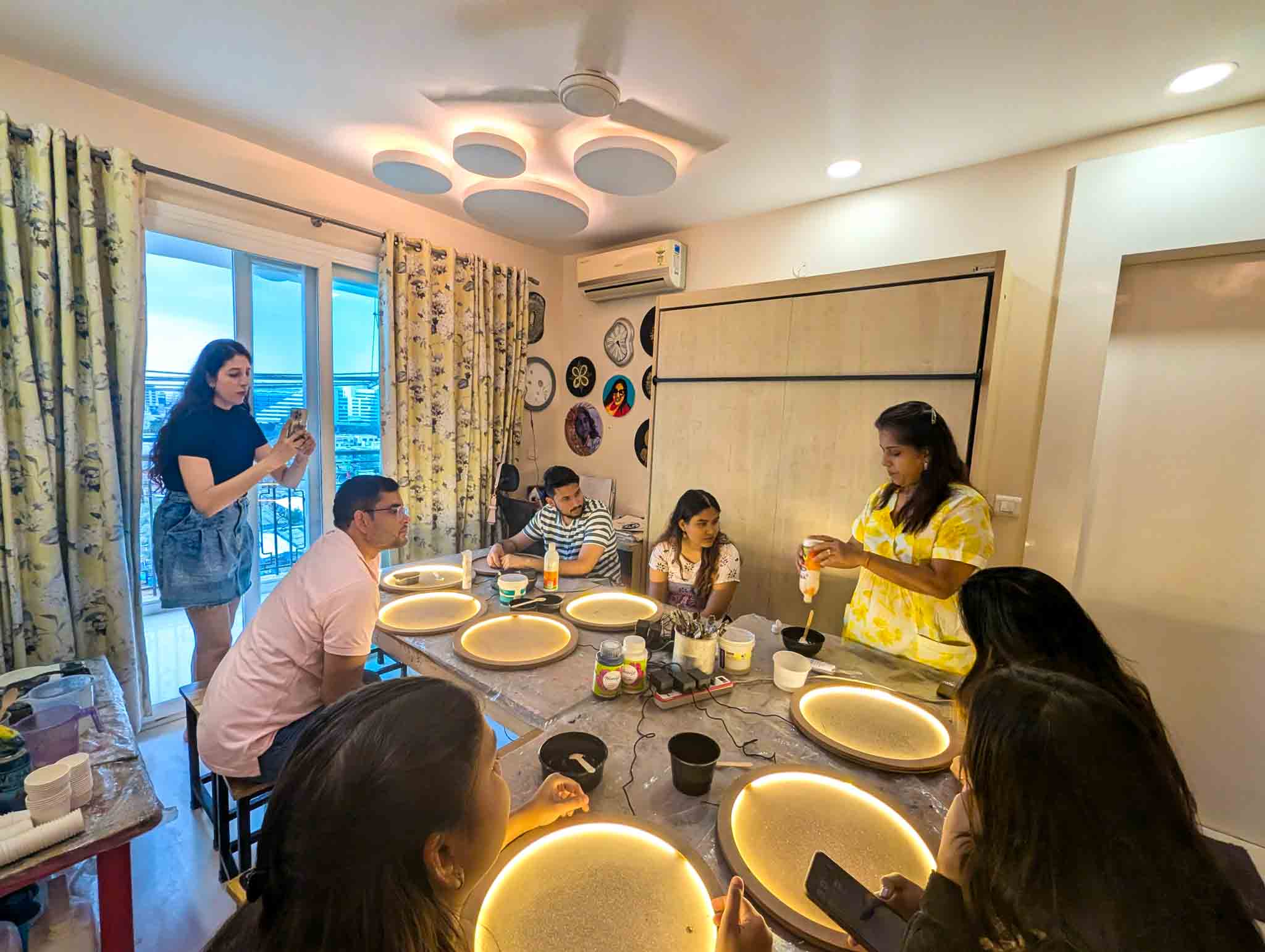 Participants engaged in moon lamp making workshop with instructor demonstrating techniques.